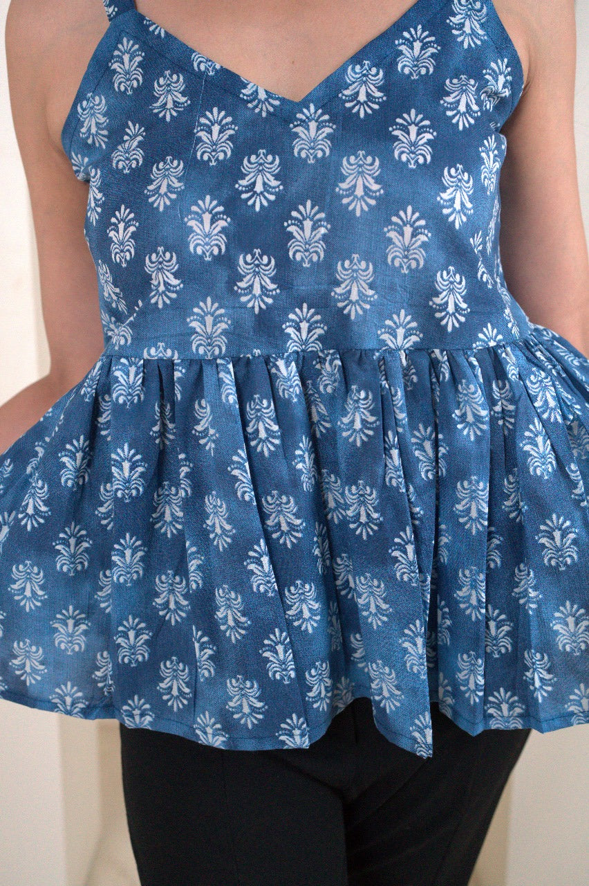 Blue floral dress with ruffled skirt worn by a person.